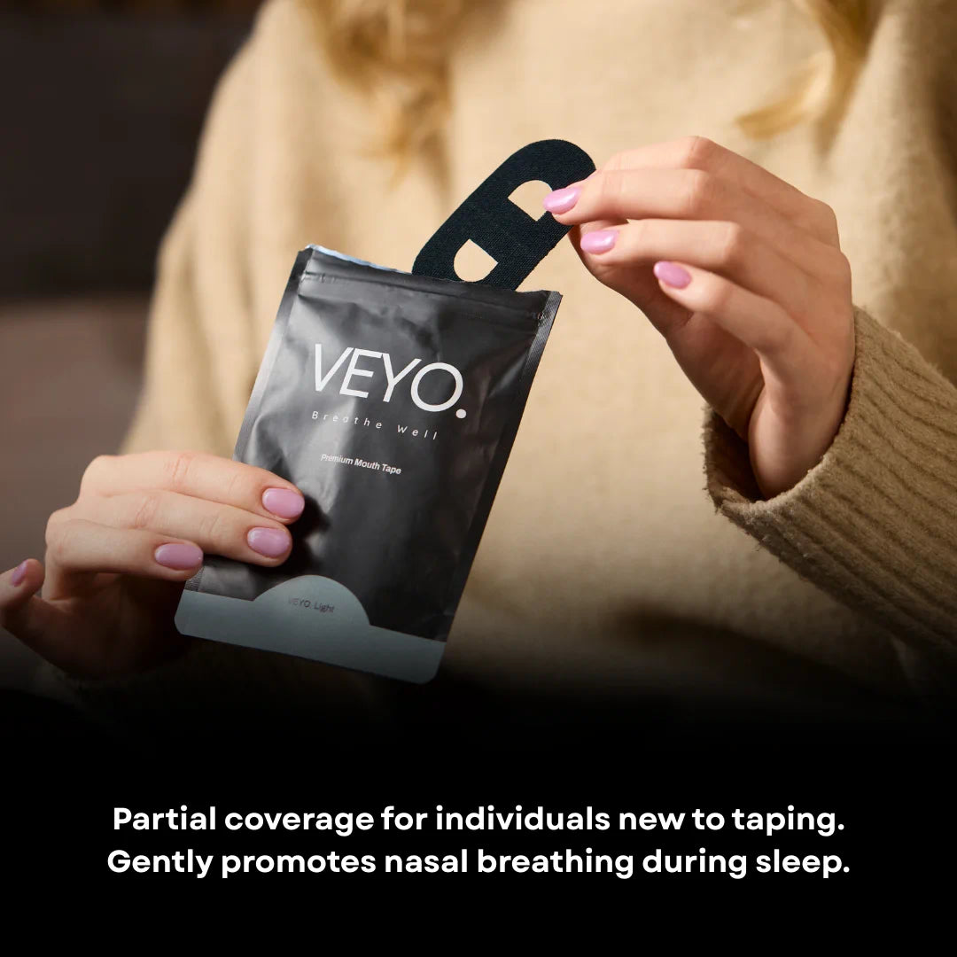 Woman holding VEYO. Light Mouth Tape