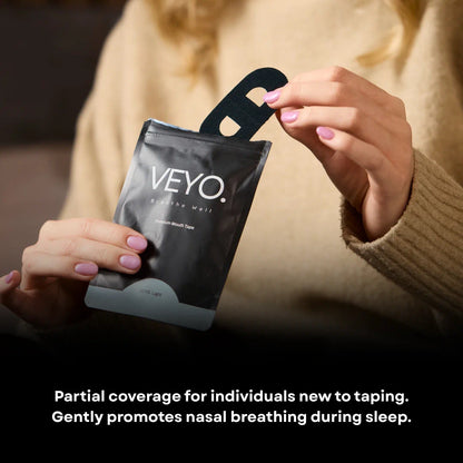 Woman holding VEYO. Light Mouth Tape